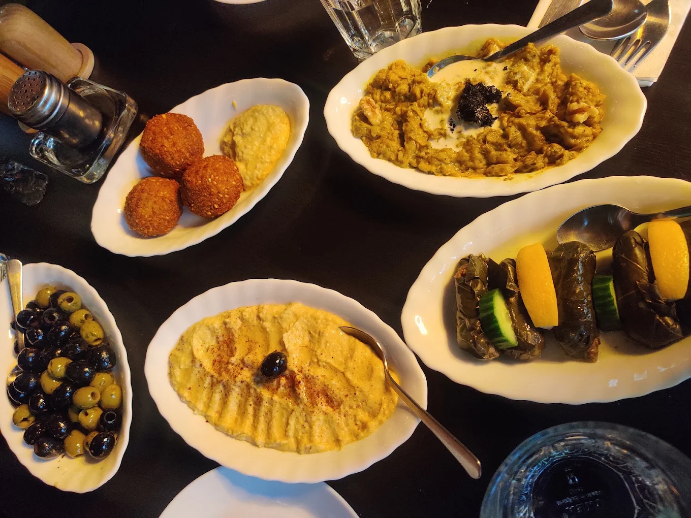 Plates of hummus, falafel, and stuffed vine leaves served at Toranj Restaurant in Edinburgh.