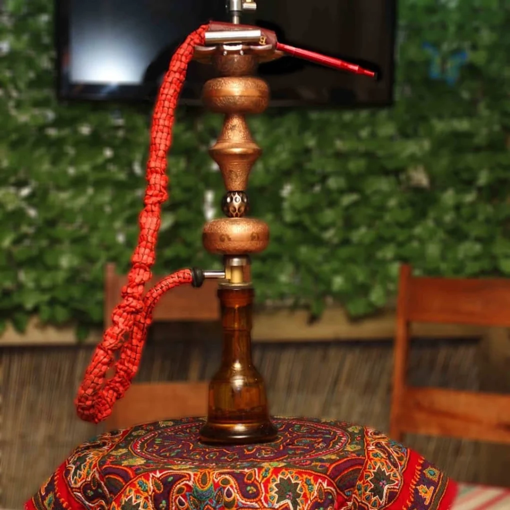 Traditional Persian shisha pipe set on a decorative table at Toranj Restaurant in Edinburgh.