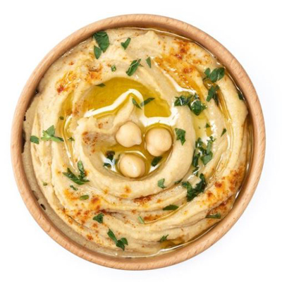 Creamy hummus dip garnished with chickpeas, herbs, and olive oil at Toranj in Edinburgh. 